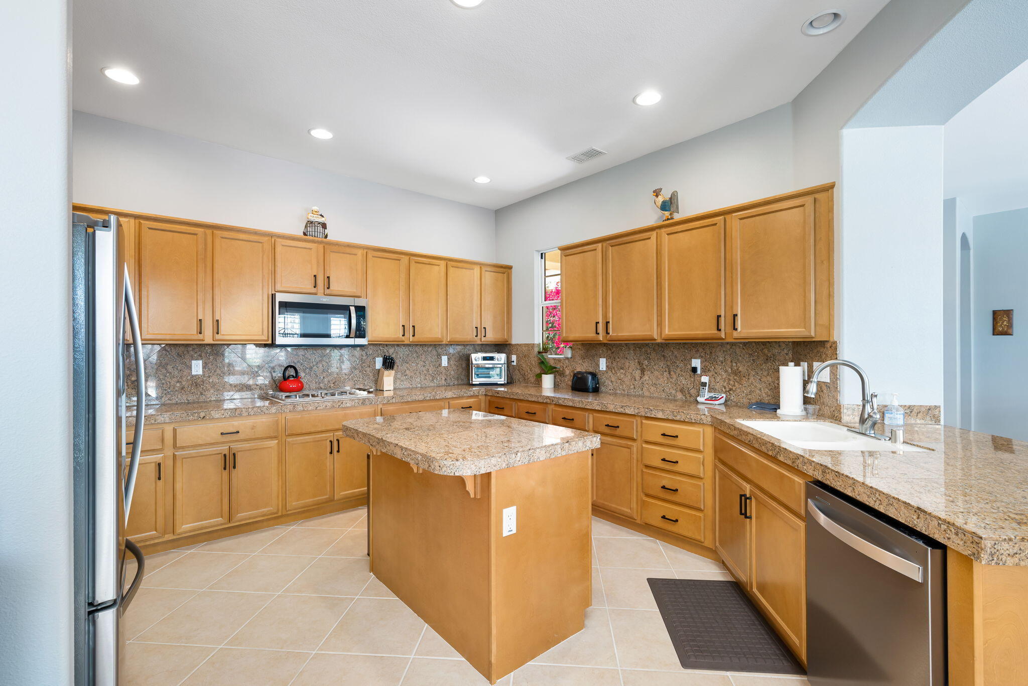 81768 Daniel Drive La Quinta, CA 92253 - Photo 13 of 81 a kitchen with stainless steel appliances granite countertop a sink stove and refrigerator