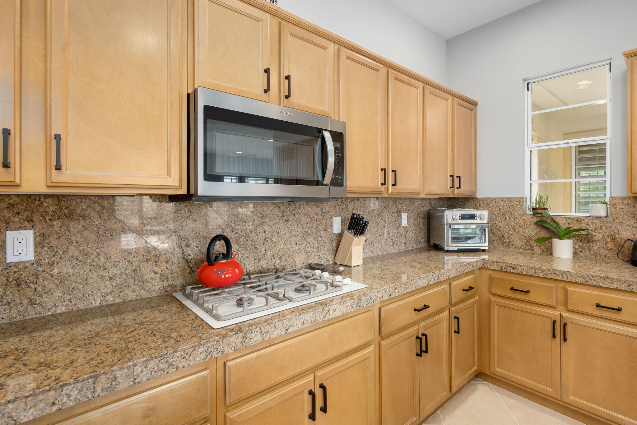 81768 Daniel Drive La Quinta, CA 92253 - Photo 17 of 81 a kitchen with granite countertop cabinets stainless steel appliances a sink and wooden floor