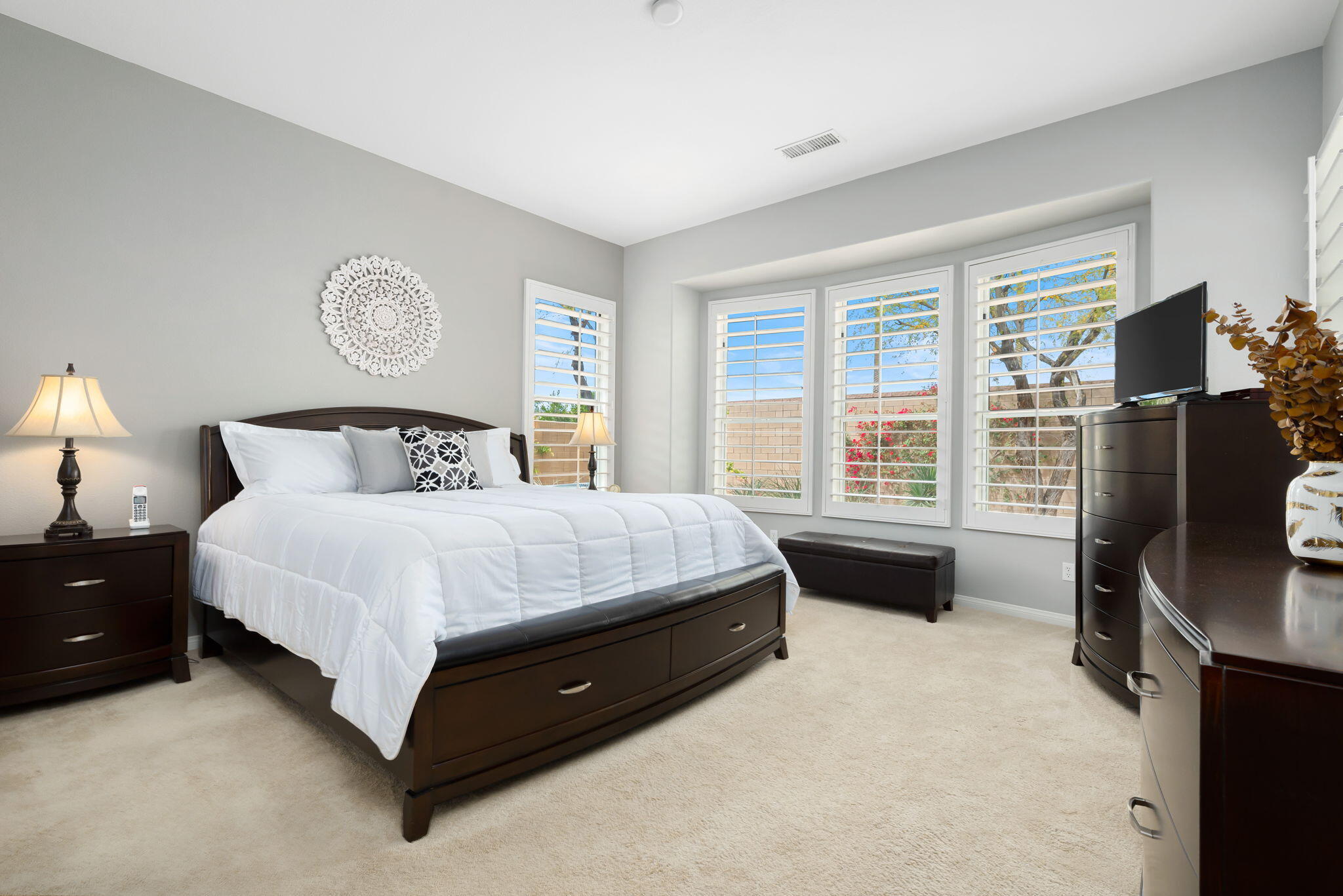 81768 Daniel Drive La Quinta, CA 92253 - Photo 19 of 81 a bedroom with a bed dresser and a flat tv screen on a dresser