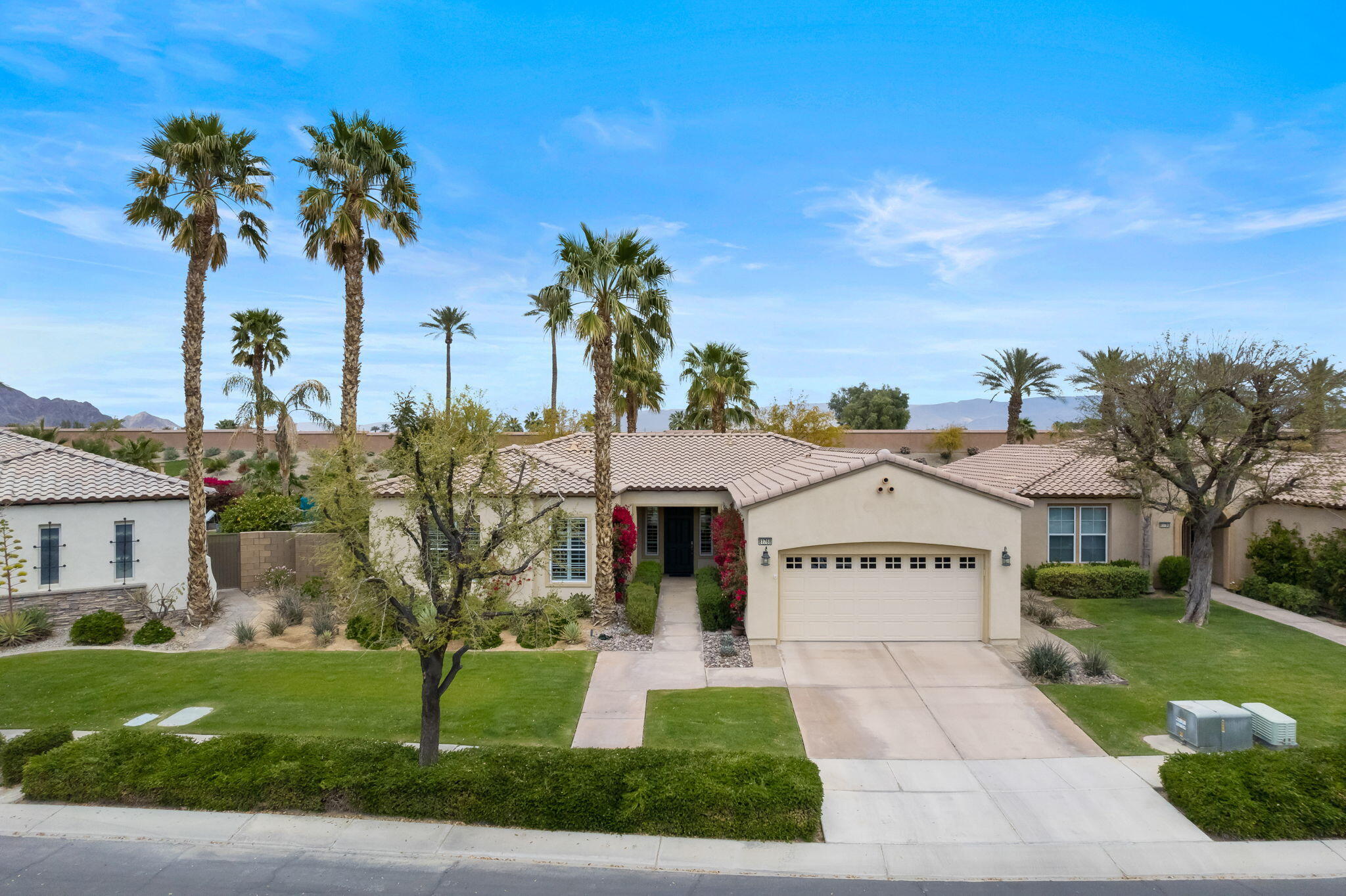 81768 Daniel Drive La Quinta, CA 92253 - Photo 2 of 81 a view of a house with a yard and potted plants