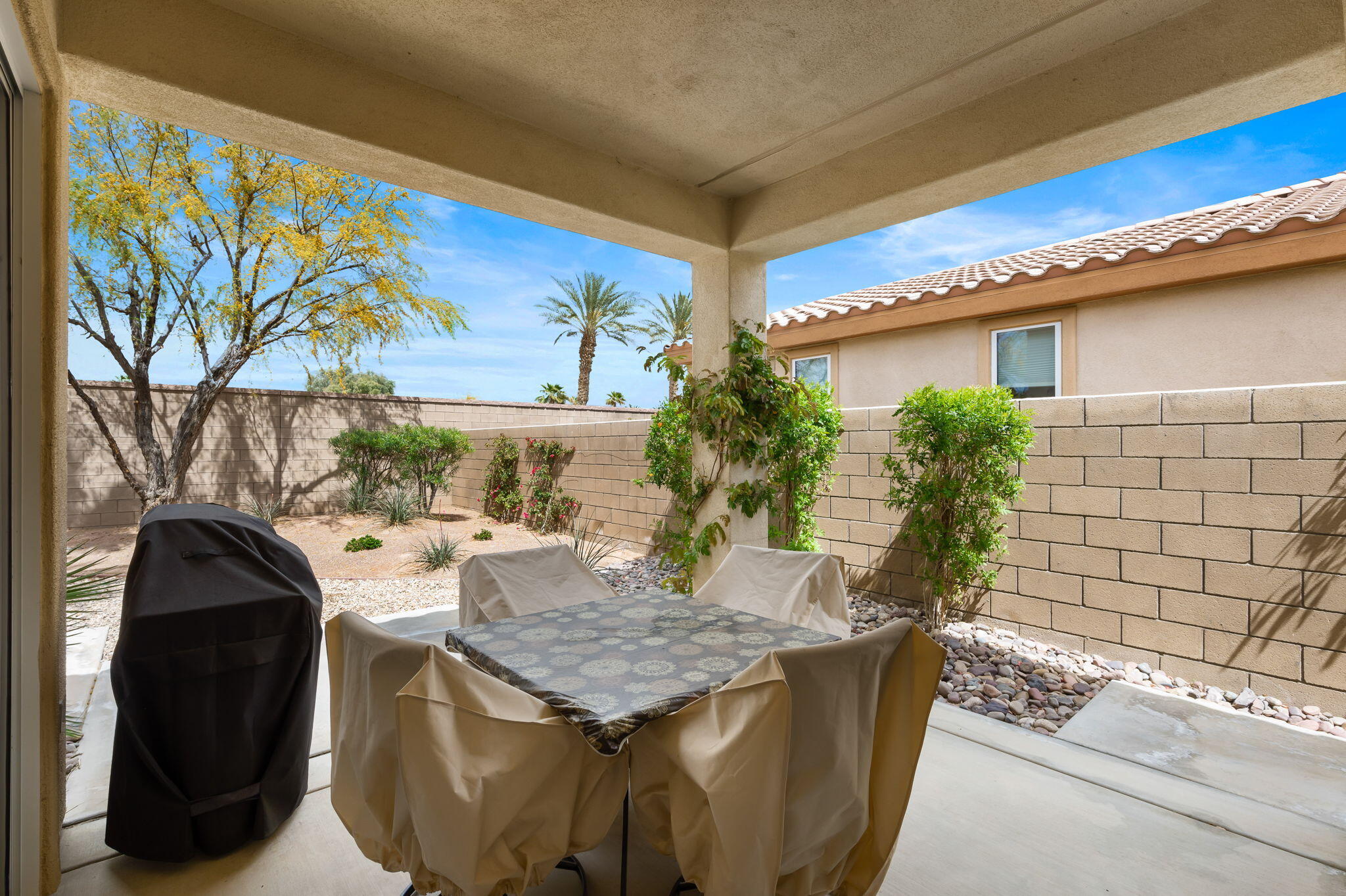81768 Daniel Drive La Quinta, CA 92253 - Photo 28 of 81 a table and chairs in front of a door