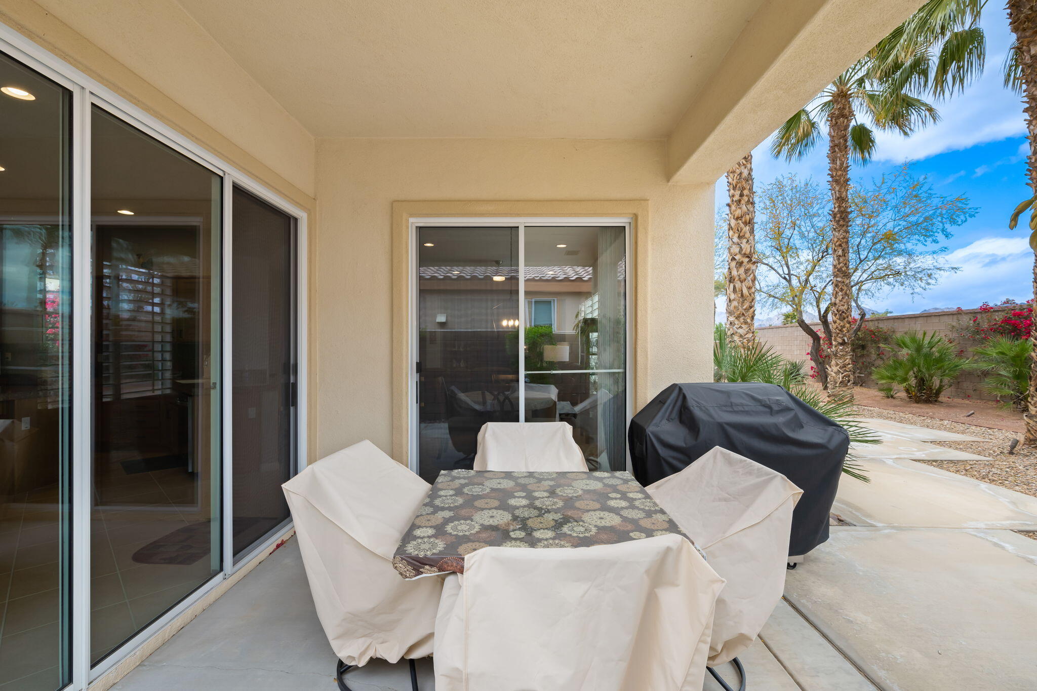81768 Daniel Drive La Quinta, CA 92253 - Photo 30 of 81 a living room with furniture and a floor to ceiling window