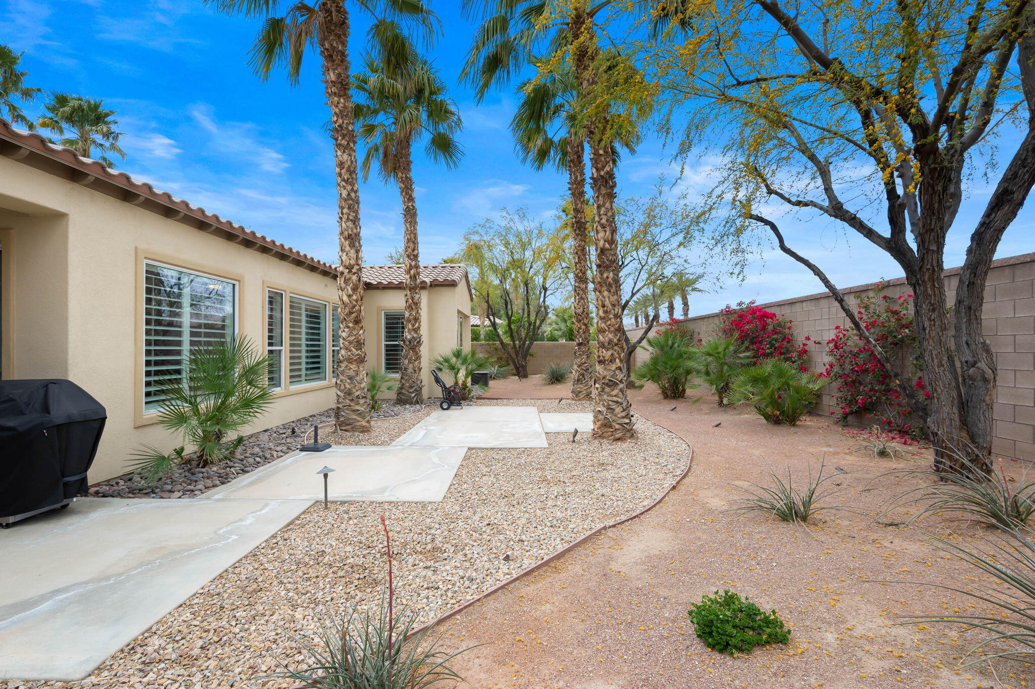 81768 Daniel Drive La Quinta, CA 92253 - Photo 32 of 81 a patio with a table and chairs and potted plants