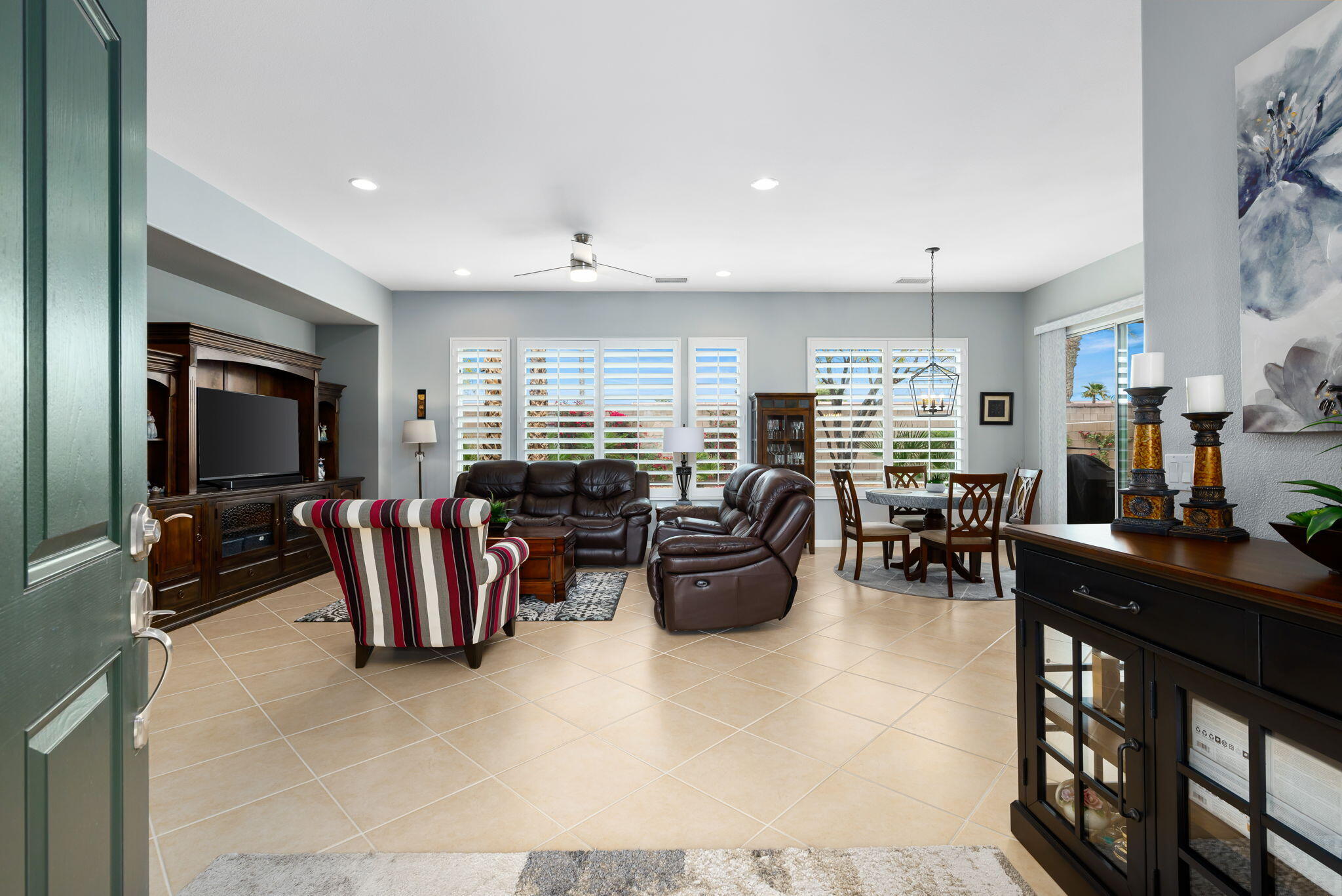 81768 Daniel Drive La Quinta, CA 92253 - Photo 4 of 81 a living room with furniture a flat screen tv and a large window
