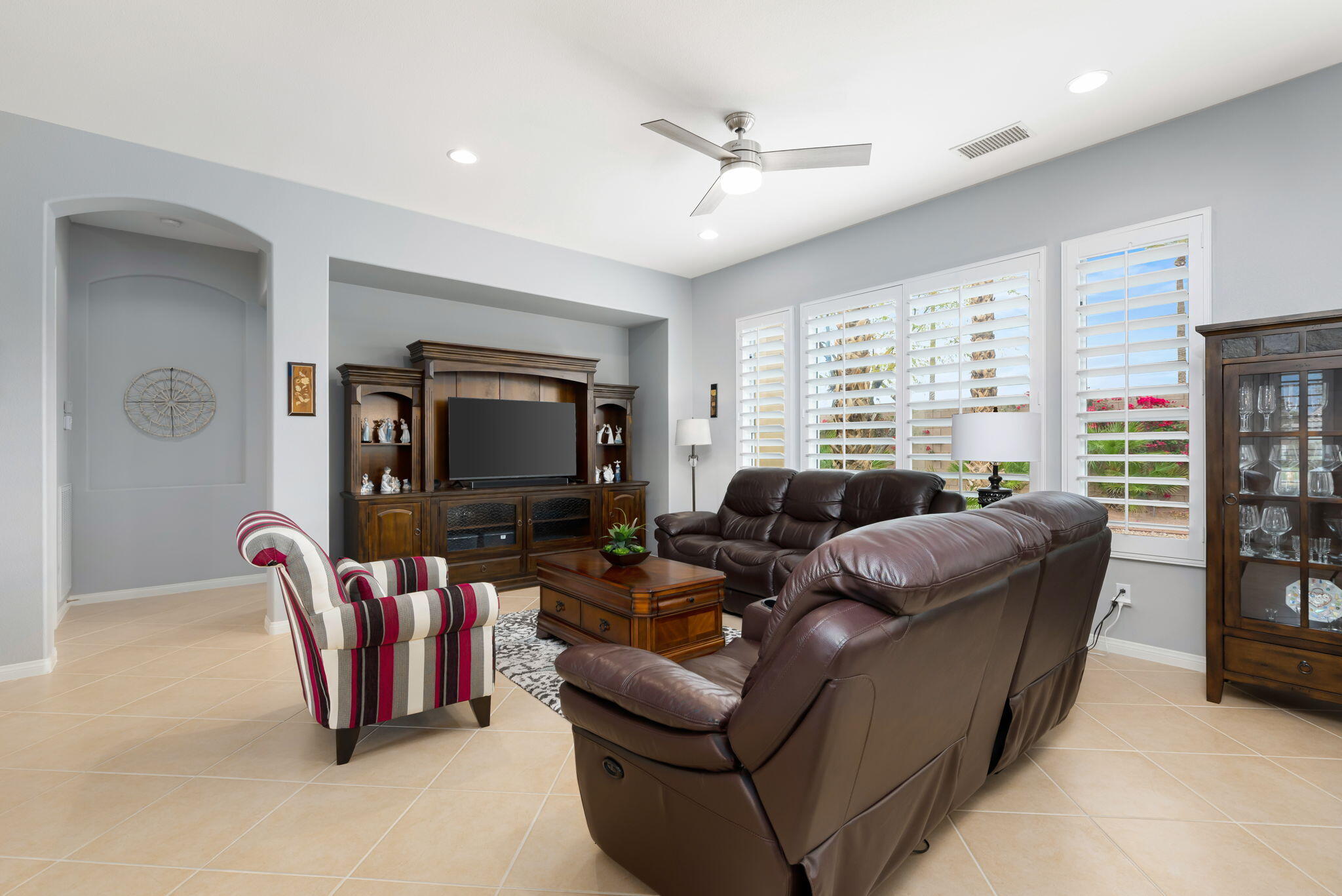 81768 Daniel Drive La Quinta, CA 92253 - Photo 5 of 81 a living room with furniture a large window and a flat screen tv