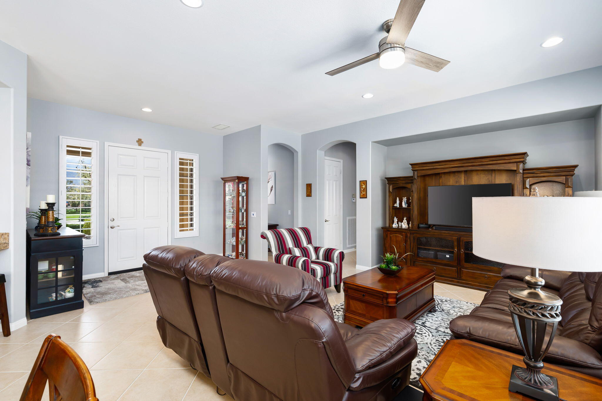81768 Daniel Drive La Quinta, CA 92253 - Photo 7 of 81 a living room with furniture a ceiling fan and a window