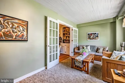 a reading room with furniture and rug
