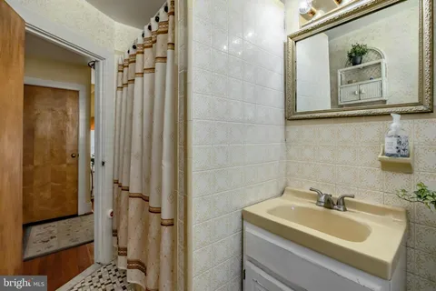 a bathroom with a shower toilet and a window