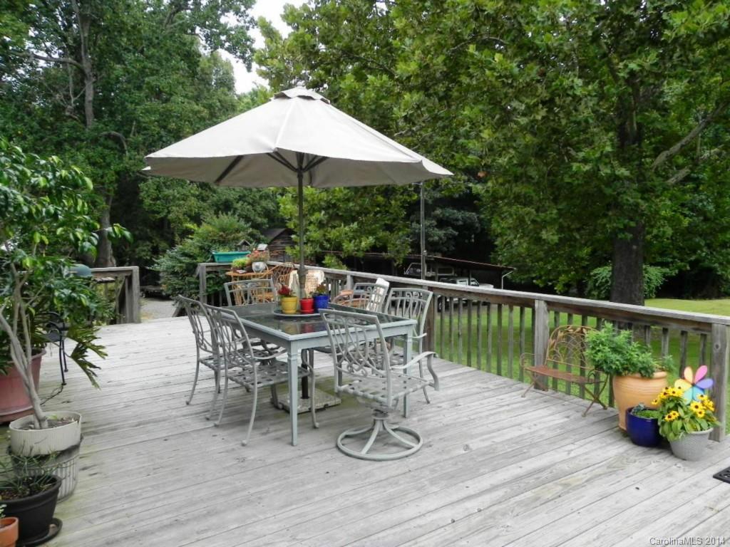 5930 Pagemont Road Kannapolis, NC 28081 - Photo 21 of 24 a patio with wooden floor a yard a table and chairs