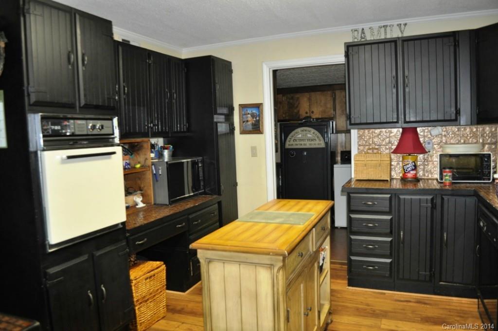 5930 Pagemont Road Kannapolis, NC 28081 - Photo 9 of 24 a kitchen with a refrigerator and a stove top oven