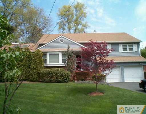 22 Chandler Road Edison, NJ 08820 - Photo 1 of 8 a front view of a house with a garden