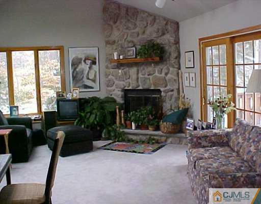 22 Chandler Road Edison, NJ 08820 - Photo 3 of 8 a living room with furniture and a fireplace