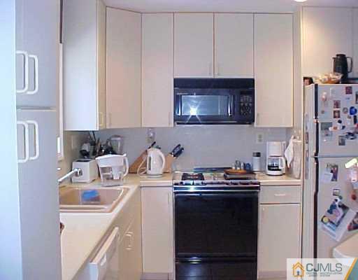22 Chandler Road Edison, NJ 08820 - Photo 6 of 8 a kitchen with cabinets a sink and appliances