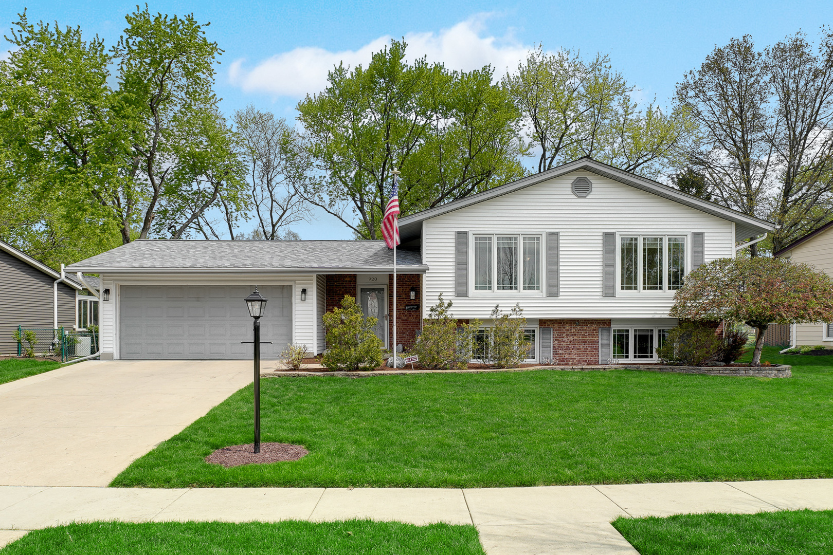 a front view of a house with a garden and yard