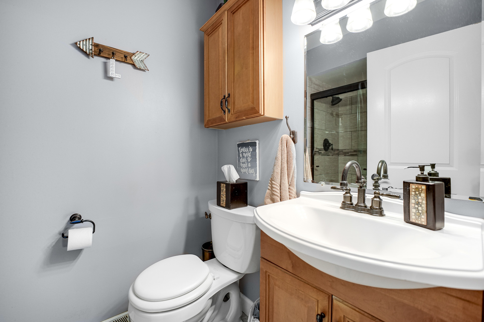 920 Harrison Lane Hoffman Estates, IL 60192 - Photo 13 of 26 a bathroom with a sink a toilet and mirror