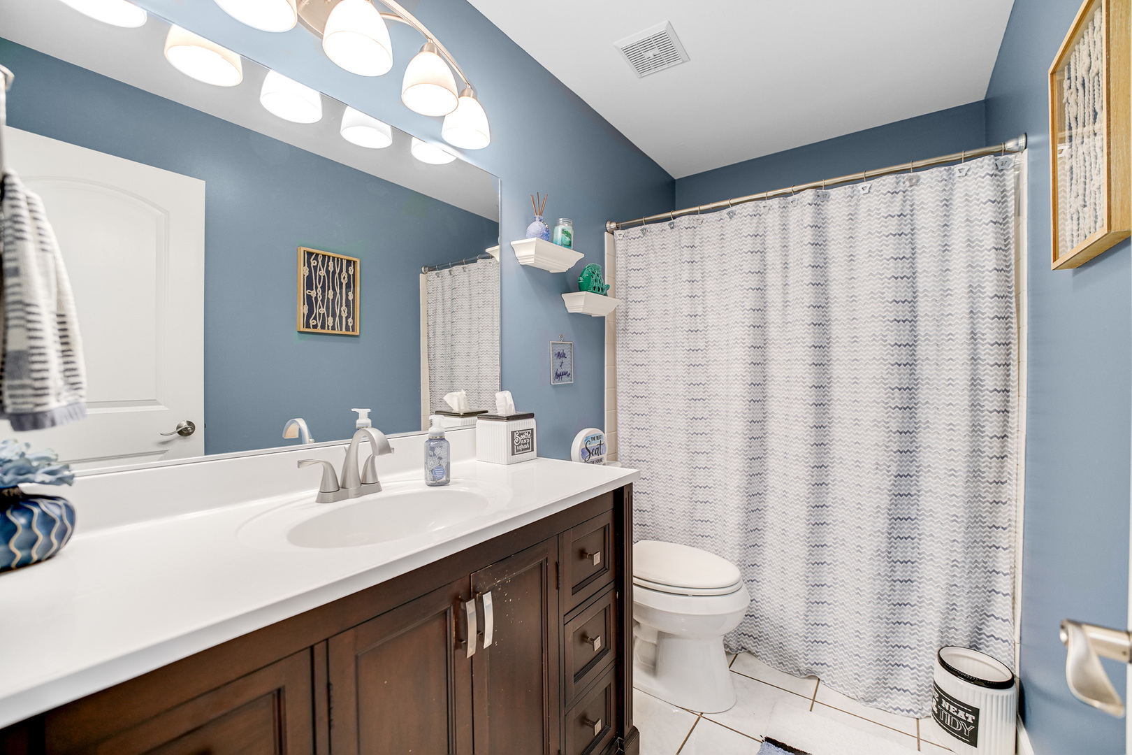 920 Harrison Lane Hoffman Estates, IL 60192 - Photo 16 of 26 a bathroom with a double vanity sink toilet and a mirror