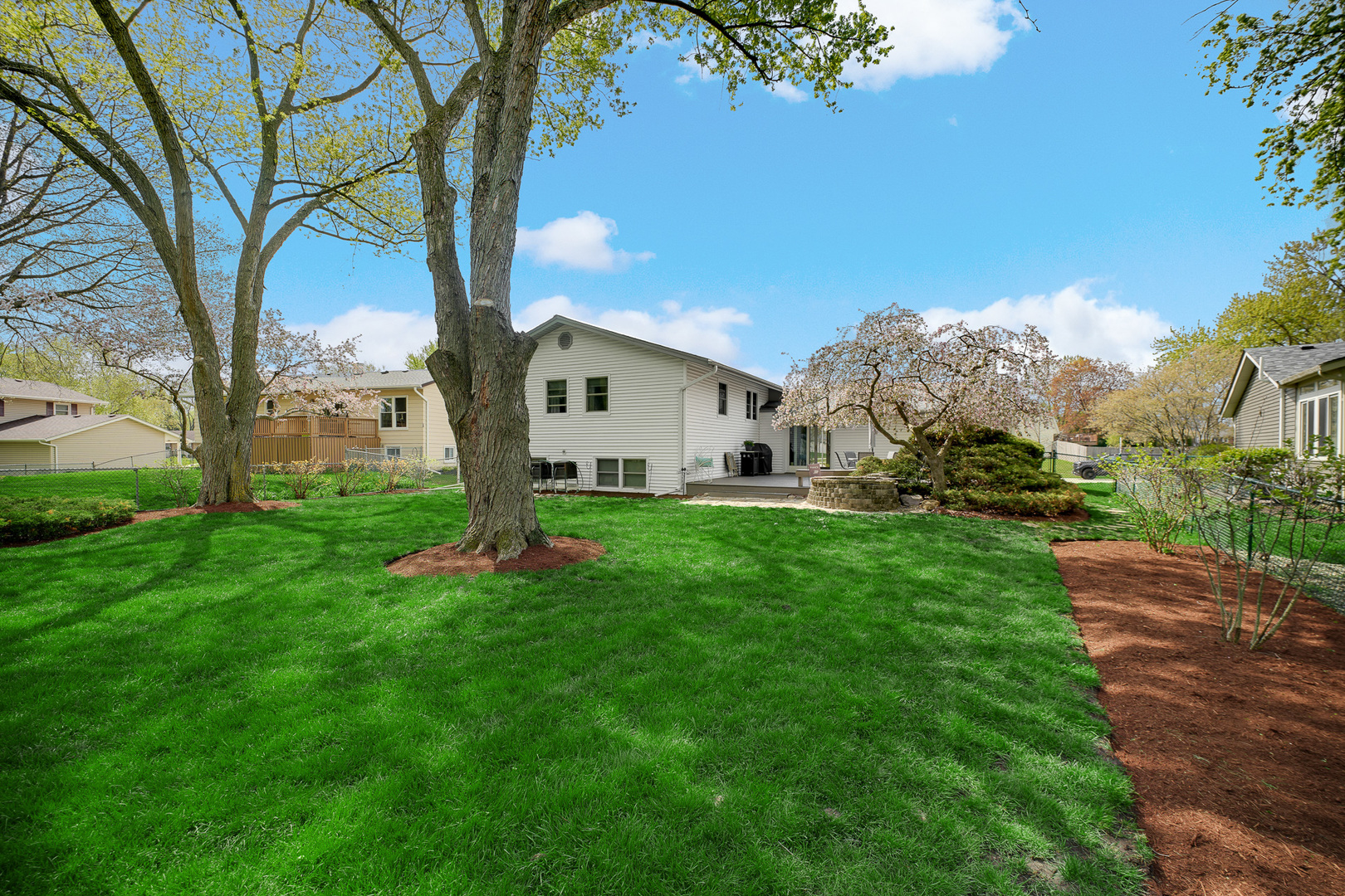 920 Harrison Lane Hoffman Estates, IL 60192 - Photo 24 of 26 a view of a white house with a big yard and large trees