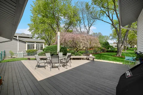a view of a patio with table and chairs and wooden floor