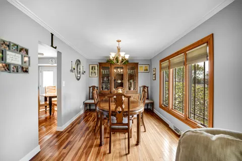 a view of a dining room with furniture and window