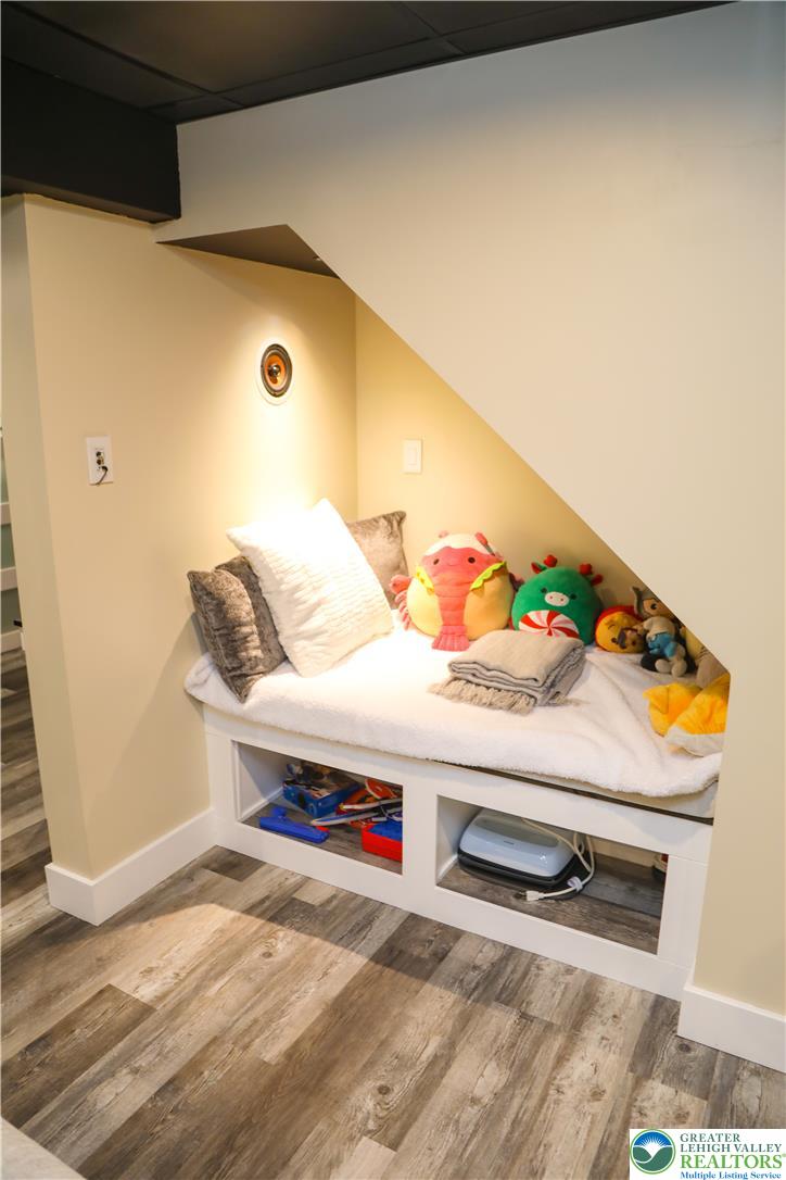 1412 Stanford Road Bethlehem, PA 18018 - Photo 50 of 58 A clever built-in bench creates a cozy nook beneath the stairs, offering comfortable seating with practical storage.