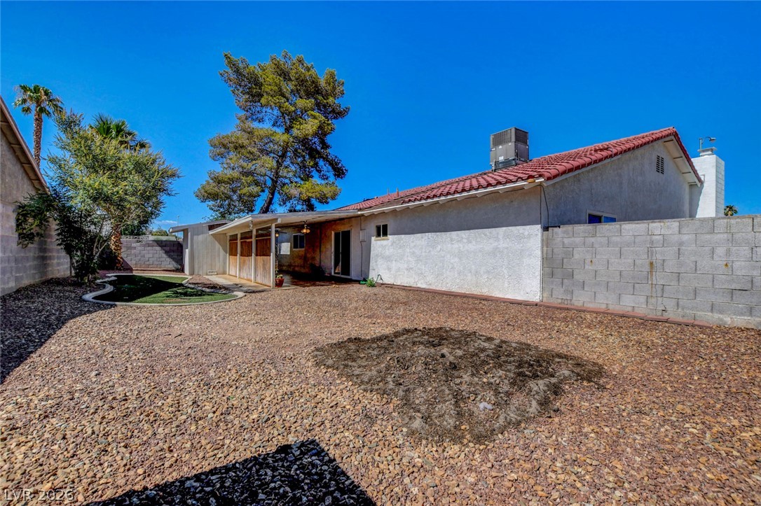 4367 South Mojave Road Las Vegas, NV 89121 - Photo 49 of 53 A spacious backyard retreat features low-maintenance gravel, a patch of vibrant green, and a covered patio area.