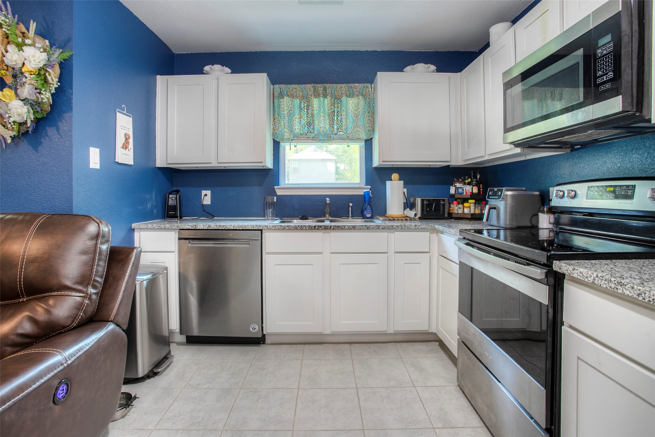 28617 Rantoul Court Point Blank, TX 77364 - Photo 12 of 29 a kitchen with a stove microwave and sink