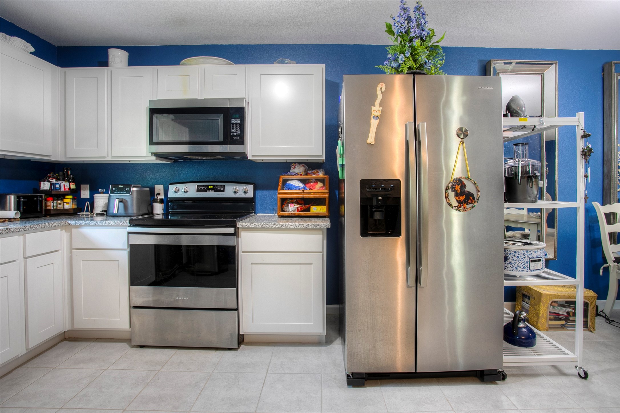 28617 Rantoul Court Point Blank, TX 77364 - Photo 13 of 29 a kitchen with stainless steel appliances a refrigerator and a stove top oven