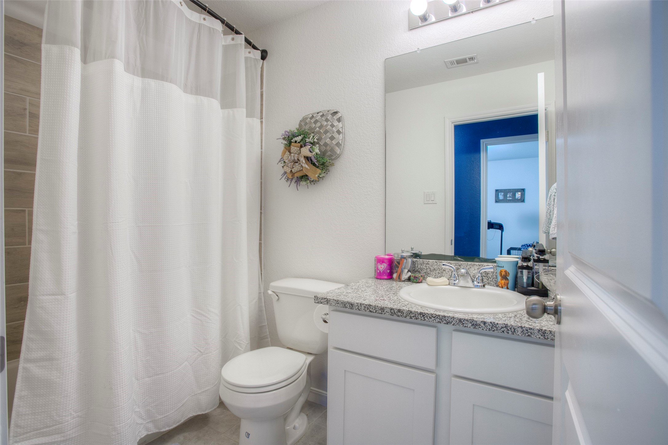 28617 Rantoul Court Point Blank, TX 77364 - Photo 19 of 29 a bathroom with a granite countertop sink and a mirror