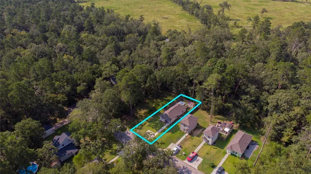 a view of multi story residential apartment building with a yard and large trees