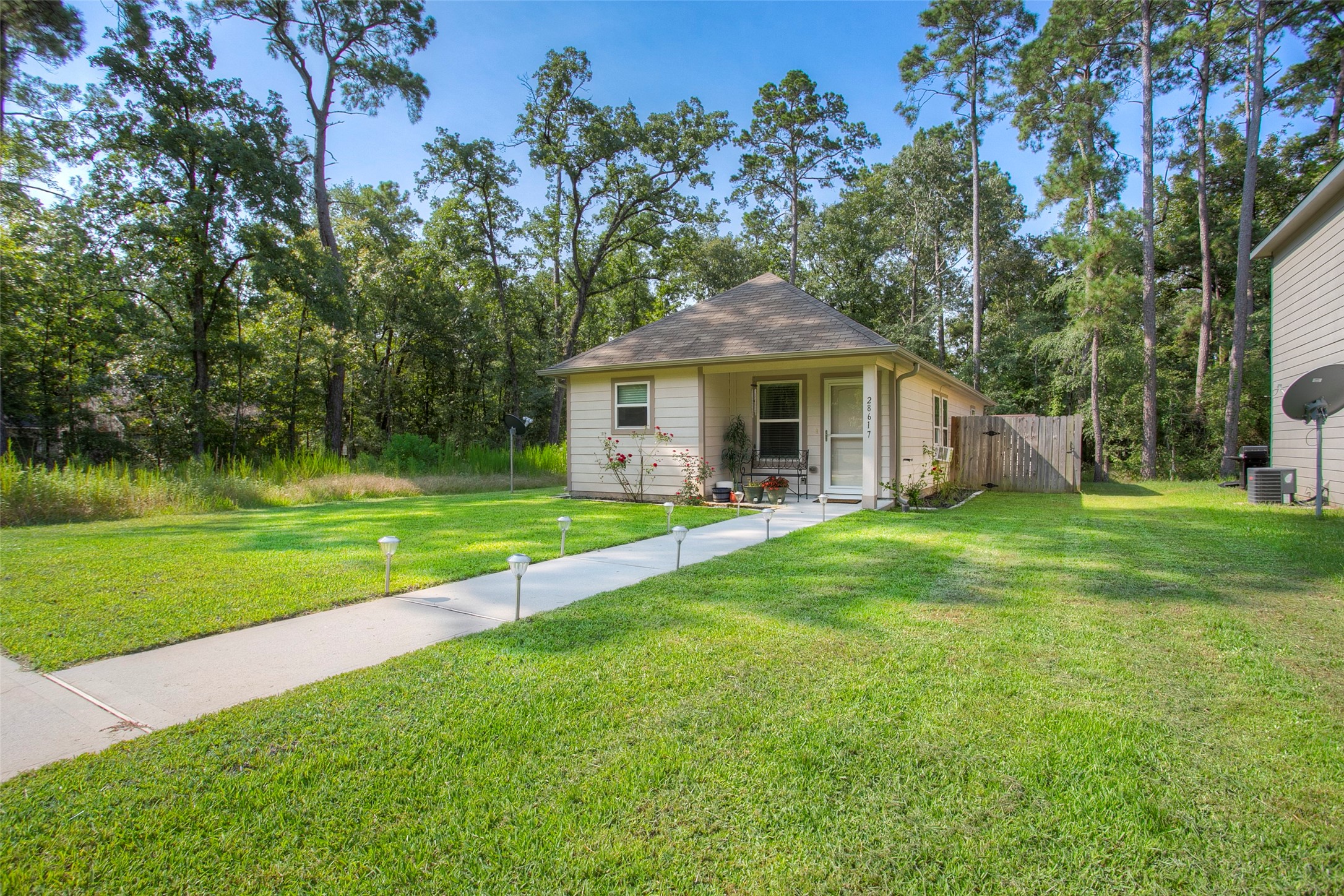 28617 Rantoul Court Point Blank, TX 77364 - Photo 5 of 29 a front view of a house with a yard porch and outdoor seating