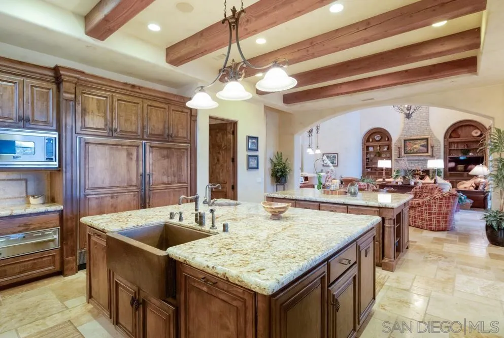 16537 Rd To Rio San Diego, CA 92127 - Photo 14 of 30 a kitchen with stainless steel appliances granite countertop a sink and cabinets
