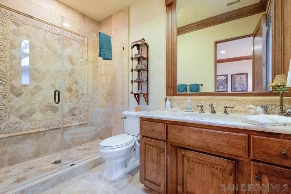 16537 Rd To Rio San Diego, CA 92127 - Photo 21 of 30 a bathroom with a granite countertop sink a toilet a mirror and shower