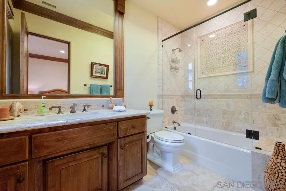 16537 Rd To Rio San Diego, CA 92127 - Photo 23 of 30 a bathroom with a double vanity sink toilet mirror and shower