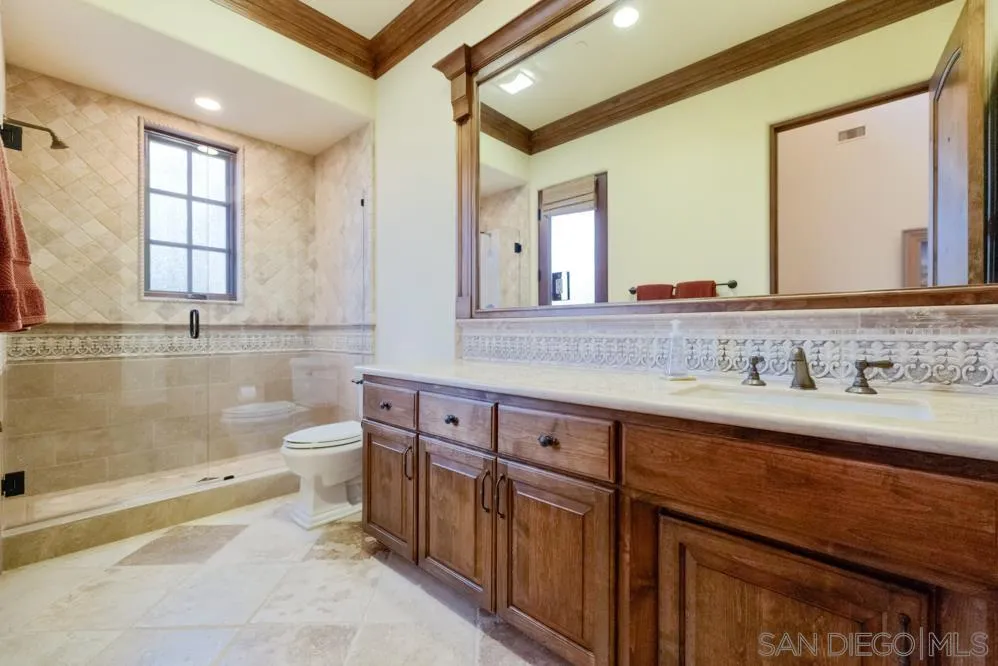 16537 Rd To Rio San Diego, CA 92127 - Photo 25 of 30 a spacious bathroom with a granite countertop double vanity sink a mirror and a bathtub