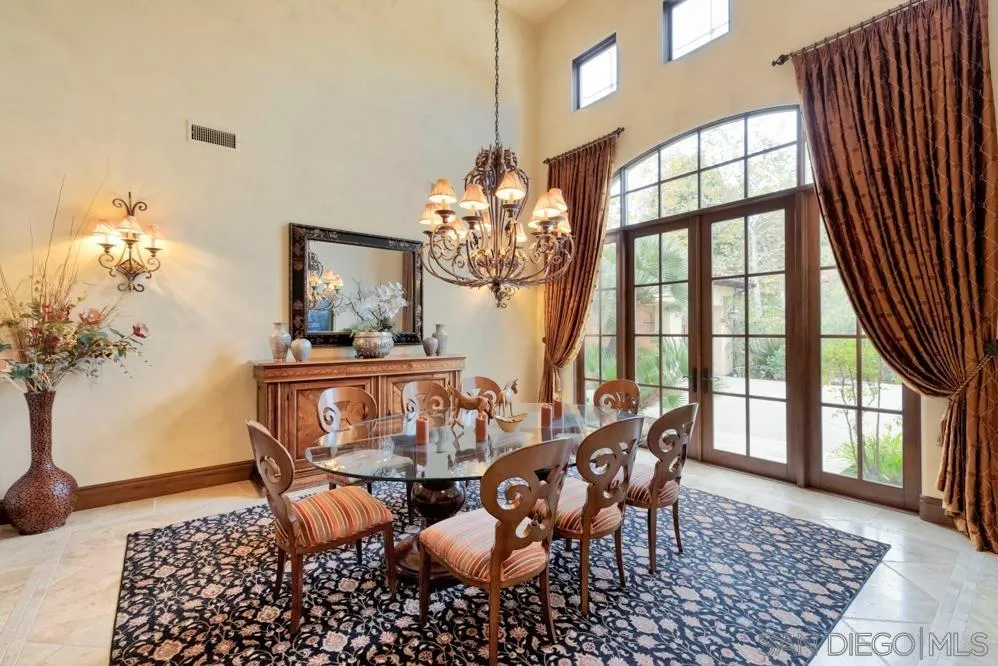 16537 Rd To Rio San Diego, CA 92127 - Photo 3 of 30 a dining room with furniture a rug and a chandelier