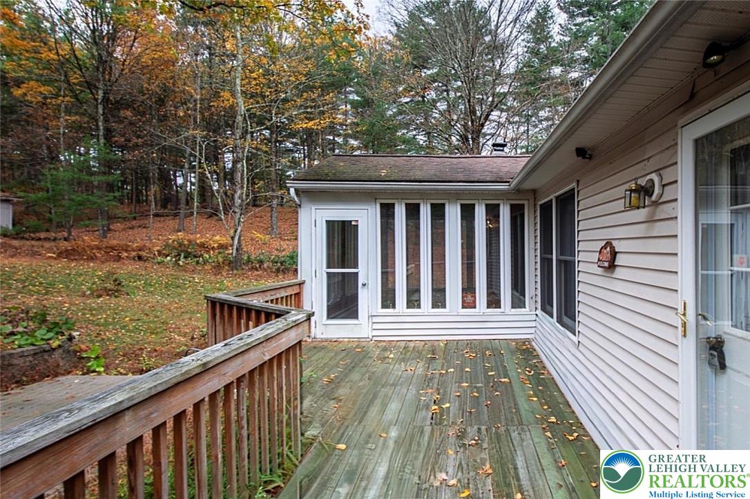 139 Johnny Bee Road Dingmans Ferry, PA 18328 - Photo 13 of 51 a view of a wooden deck and a yard