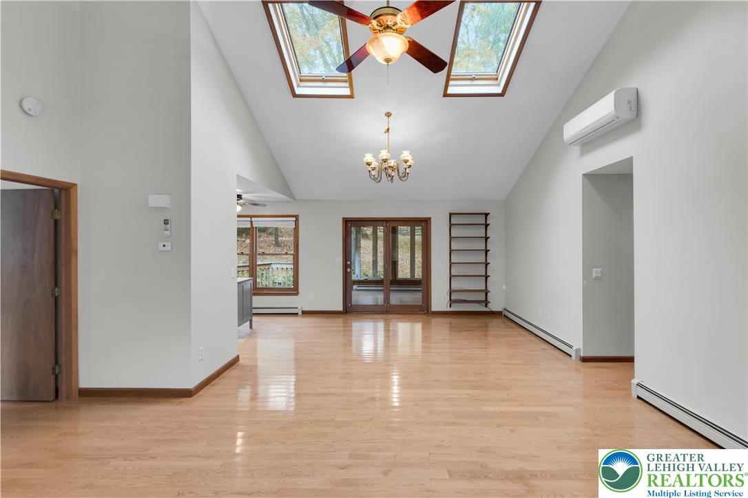 139 Johnny Bee Road Dingmans Ferry, PA 18328 - Photo 16 of 51 an empty room with windows and ceiling fan