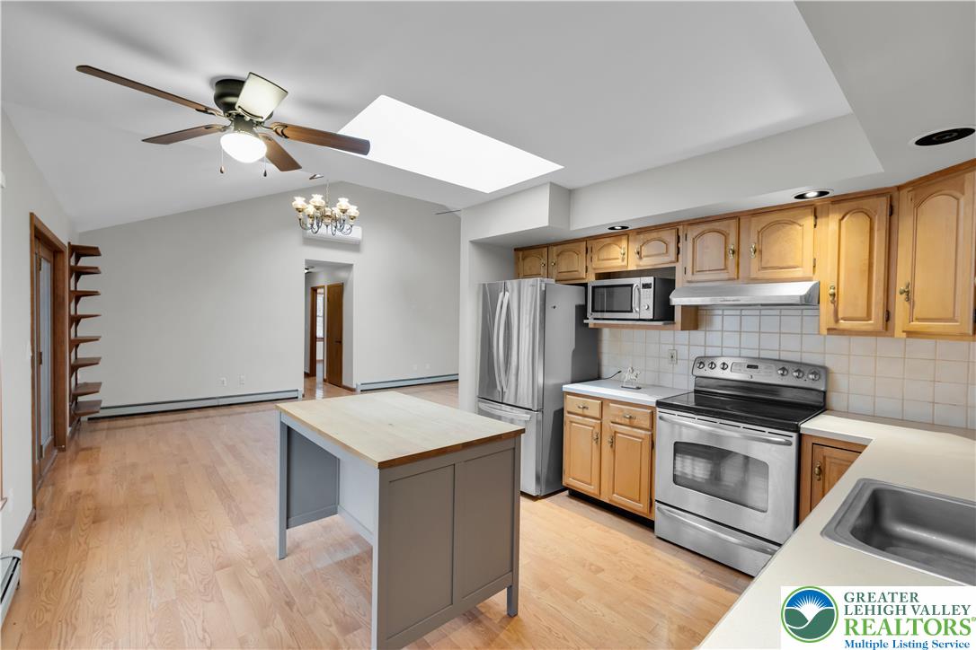 139 Johnny Bee Road Dingmans Ferry, PA 18328 - Photo 21 of 51 a kitchen with stainless steel appliances a stove a sink and a refrigerator