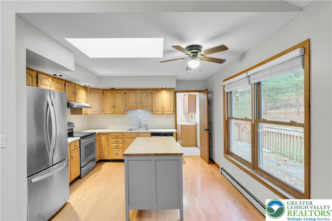 139 Johnny Bee Road Dingmans Ferry, PA 18328 - Photo 22 of 51 a large kitchen with stainless steel appliances granite countertop a refrigerator a oven a stove and a refrigerator