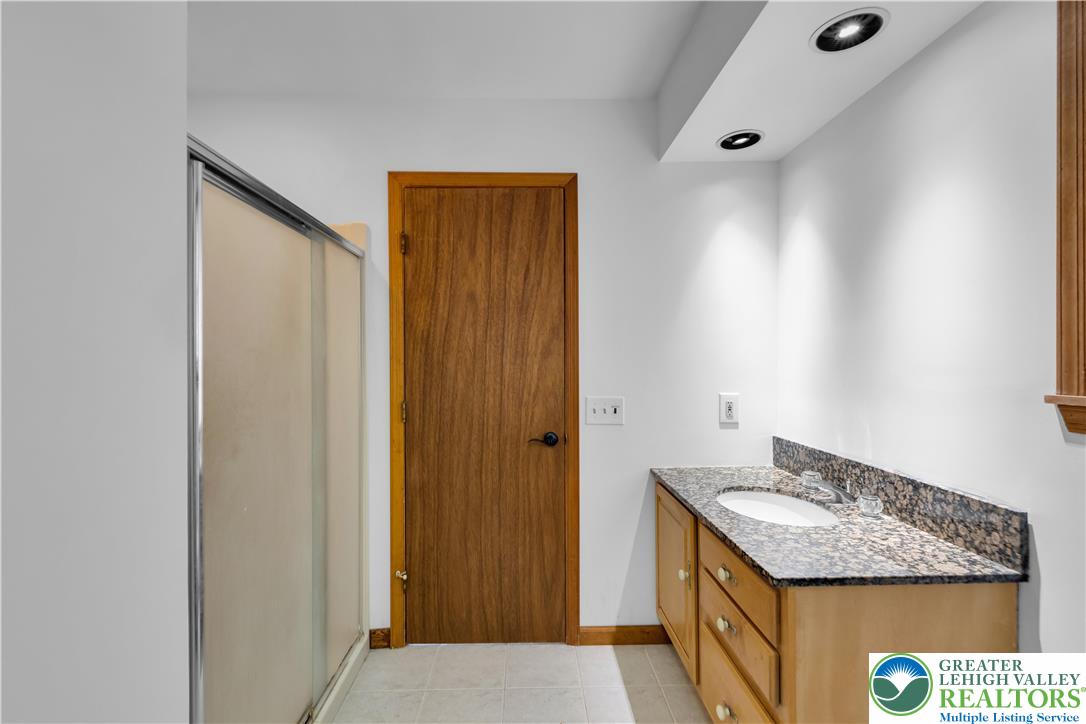 139 Johnny Bee Road Dingmans Ferry, PA 18328 - Photo 32 of 51 a bathroom with a granite countertop sink and a mirror