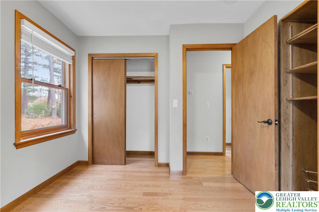 139 Johnny Bee Road Dingmans Ferry, PA 18328 - Photo 34 of 51 a view of an empty room with wooden floor and a window
