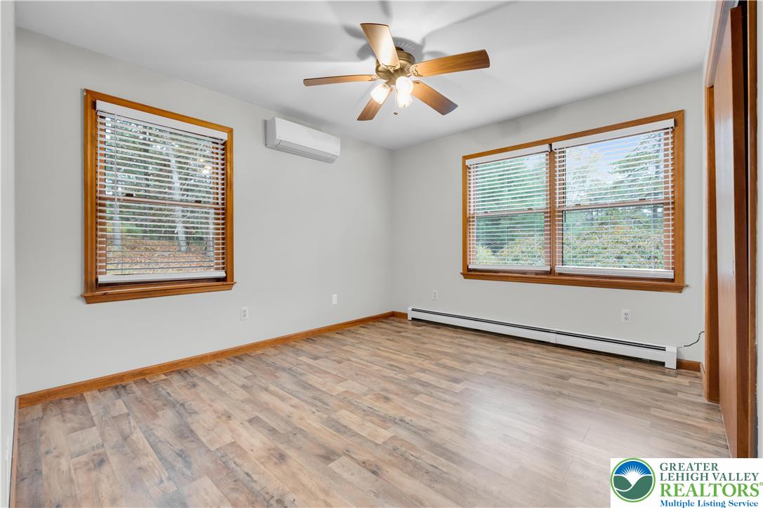 139 Johnny Bee Road Dingmans Ferry, PA 18328 - Photo 39 of 51 a view of an empty room with window and chandelier fan