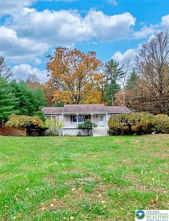 a view of a wooden deck and a yard