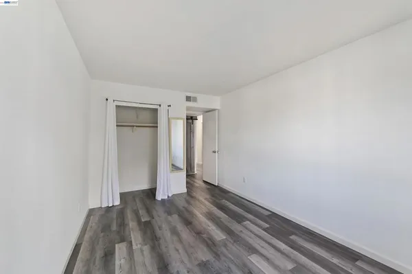 a view of a room with wooden floor
