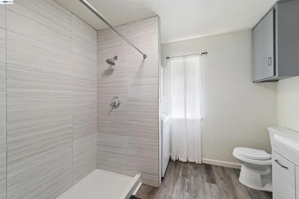 a bathroom with a toilet and a shower