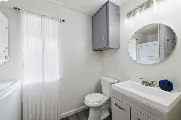 a bathroom with a sink toilet and a mirror