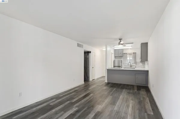 a room with wooden floor and window