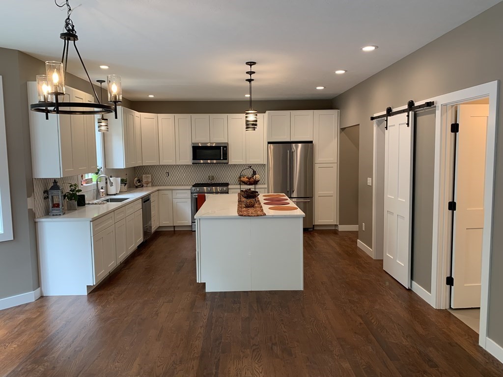 18 White Loaf Road Southampton, MA 01073 - Photo 5 of 20 a kitchen with kitchen island a counter top space a sink a refrigerator and a stove