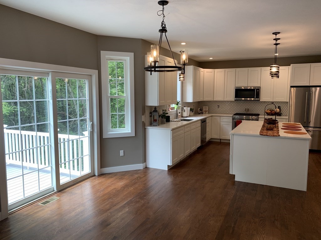 18 White Loaf Road Southampton, MA 01073 - Photo 6 of 20 a kitchen with kitchen island granite countertop a stove oven and a wooden floors