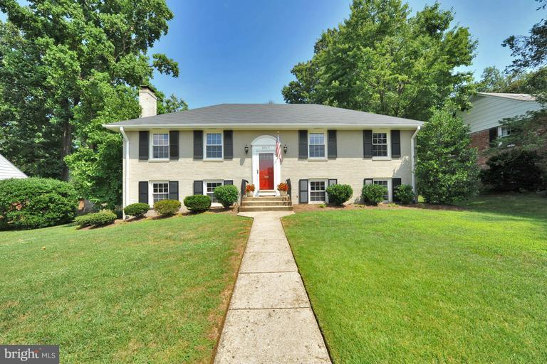 8417 Riverside Road Alexandria, VA 22308 - Photo 1 of 30 a front view of a house with a yard and trees